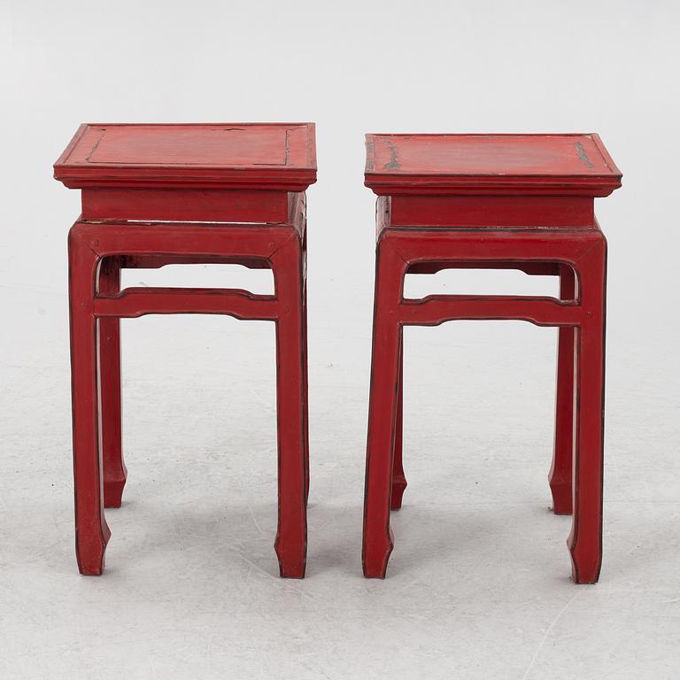 A pair of red Chinese small tables, 20th century.