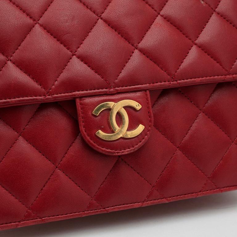 CHANEL, a red leather shoulder bag.