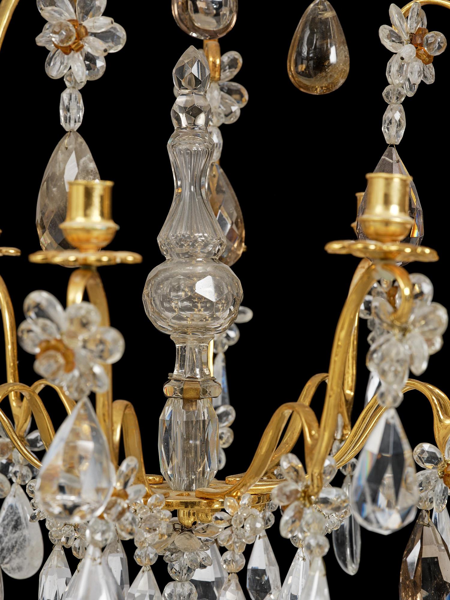 A near pair of Franch Louis-XV-style nine-branch gilt bronze and rock crystal chandeliers, later part 19th century.