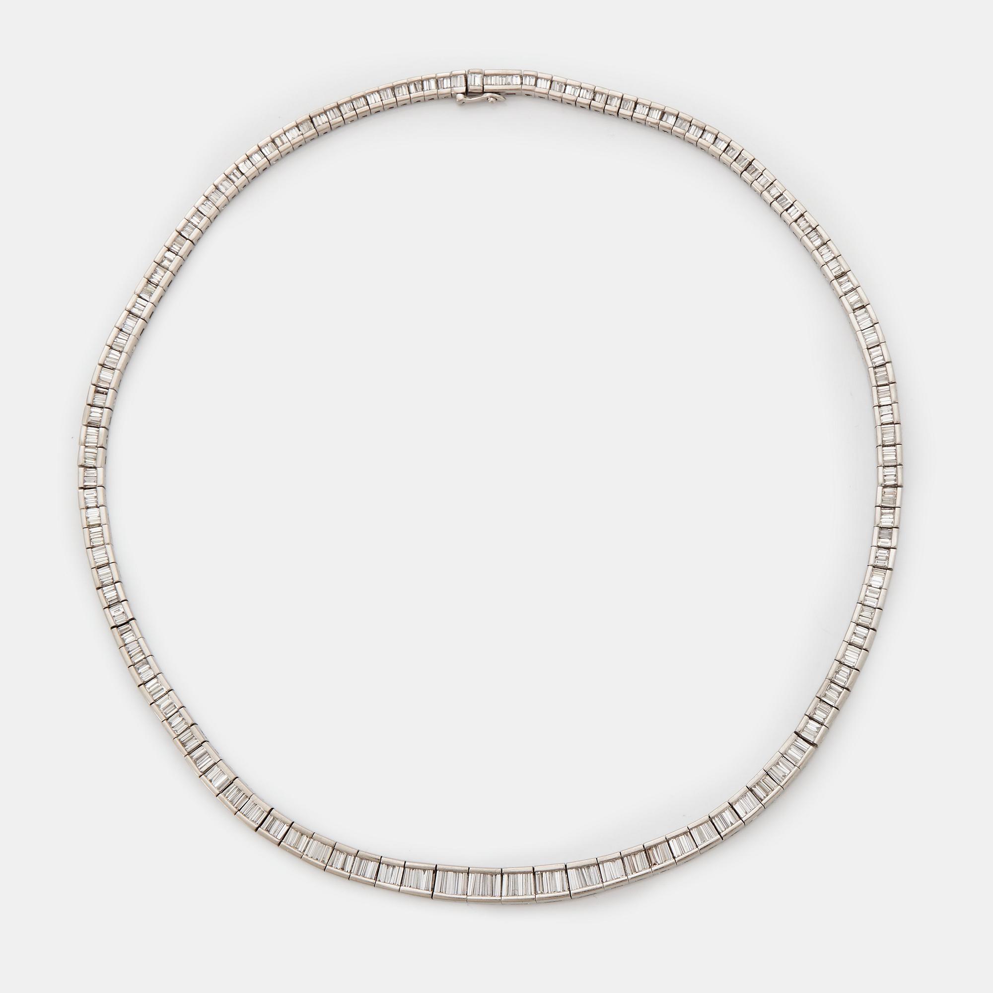 A platinum necklace set with tapered baguette-cut diamonds.