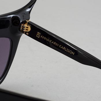 A pair of Anna-Karin Karlsson sunglasses.