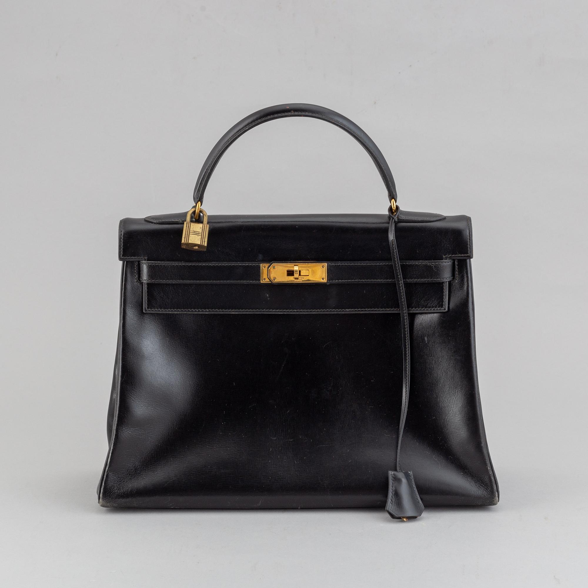 Hermès,a black leather 'Kelly 32' handbag, 1975.