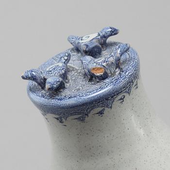 A faience candlestick and a figurine by Björn Wiinblad, signed and dated -63.