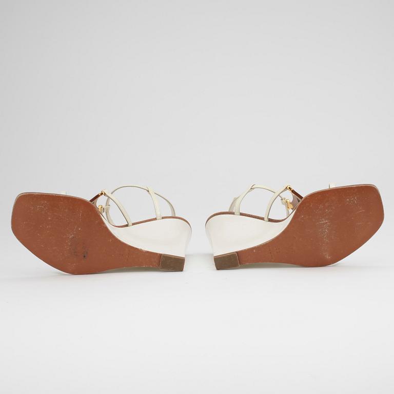 LOUIS VUITTON, a pair of white wedge heel sandalettes.