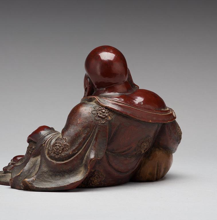 A seated wooden figure of Buddai, Qing dynasty, circa 1900.