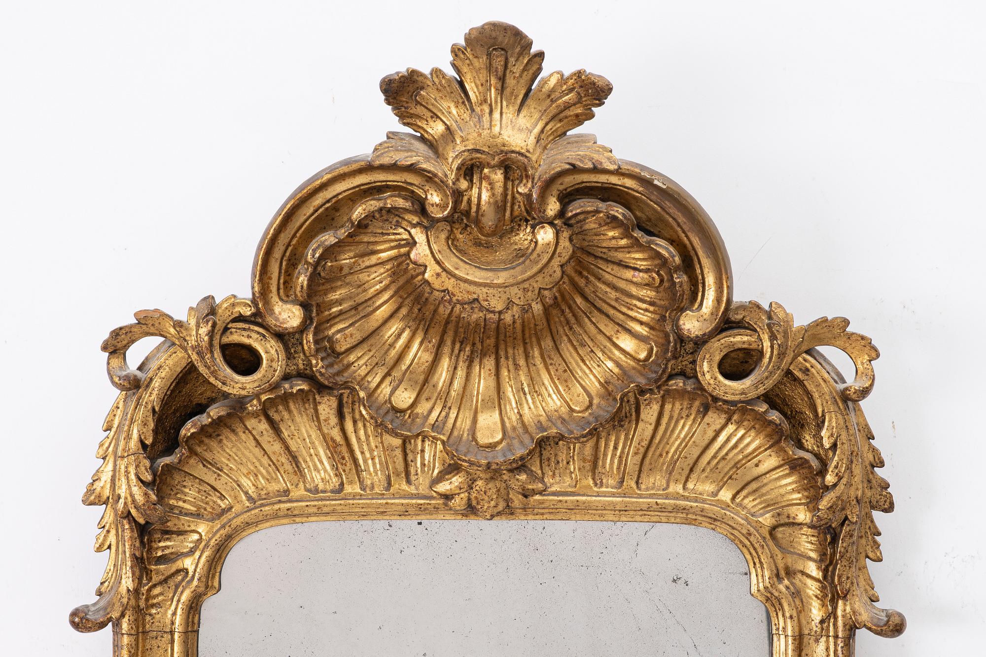 A Rococo mirror, 18th century.