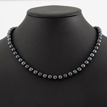 Necklace of cultured freshwater pearls, clasped with 14K white gold and round brilliant-cut diamonds.