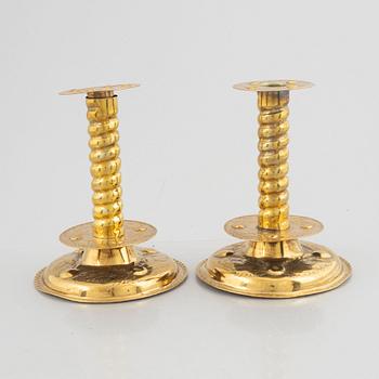 A pair of brass baroque style candlesticks, end of the 19th century.