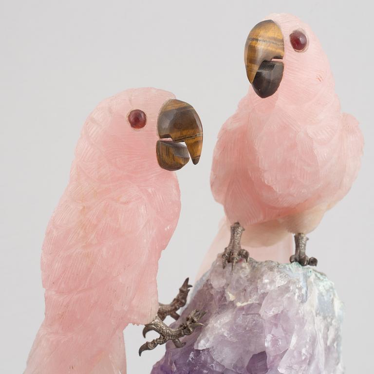 Sculpture, carved stone, birds on a quartz cliff.