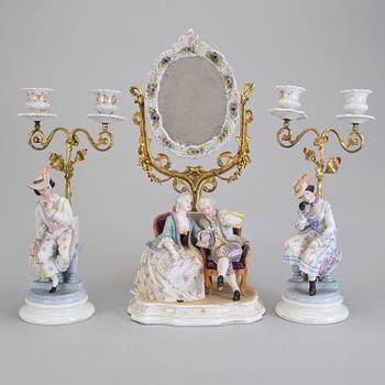 A late 18th century porcelain and biscuit toilette mirror and pair of candelabrar.