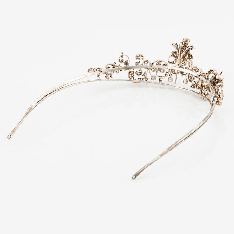 An 18K gold and silver tiara composed of scroll motifs set  with old- and rose-cut diamonds.