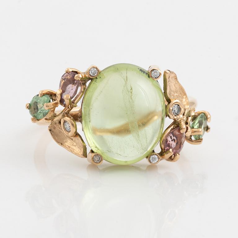 Ring with cabochon-cut peridot, tourmaline, and small diamonds.