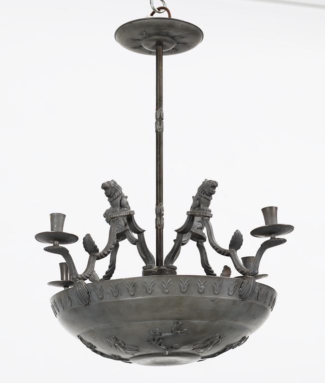 A pewter chandelier, in parts attributed to Anna Petrus, for four candles executed by Firma Svenskt Tenn in 1927.