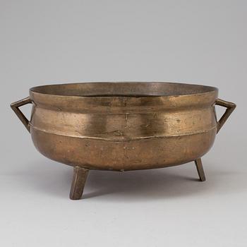 A 19th century brass cauldron.