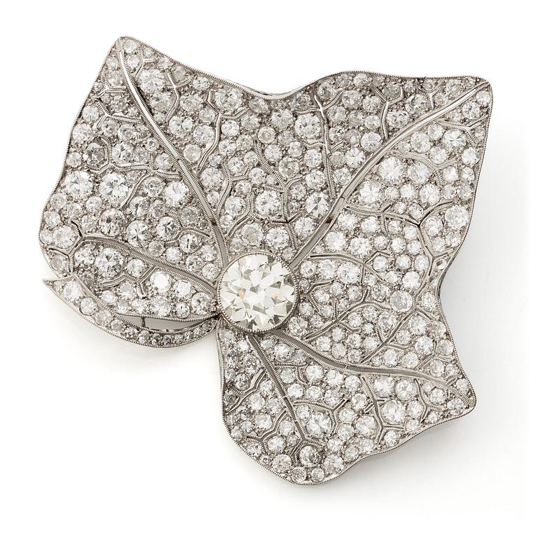 A brooch in platinum set with round brilliant-cut and eight-cut diamonds.
