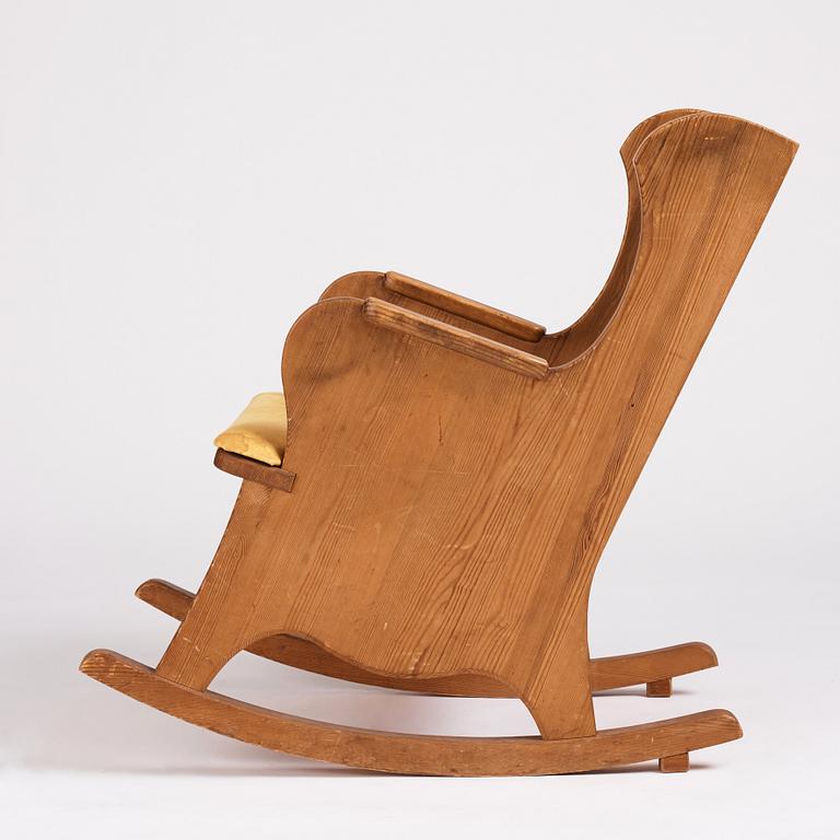 Nordiska Kompaniet, a Swedish Modern stained pine 'Lovö' rocking chair.