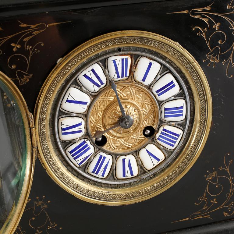 A TABLE CLOCK in stone and painted metal from the beginning of the 20th century.