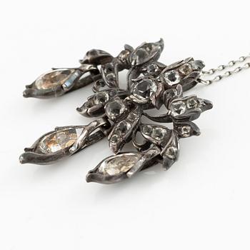 A brooch, a brooch pin, and a pendant, likely 19th century.