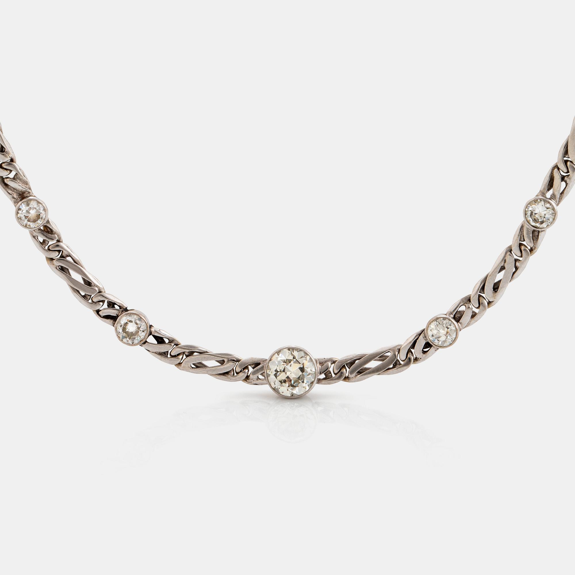 An 18K white gold necklace/bracelet combination set with round brilliant-cut diamonds.