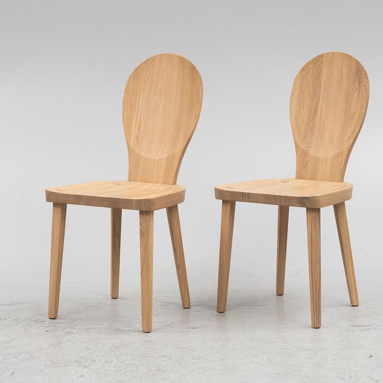 Carl Malmsten, a pair of "Skedblad" chairs, Tre Sekel, Sweden, 21st century.