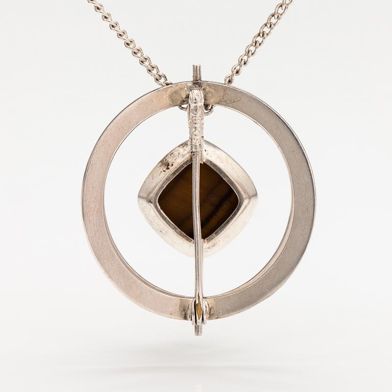Elis Kauppi, A silver necklace/brooch with a tiger's eye. Kupittaan kulta, turku 1961.
