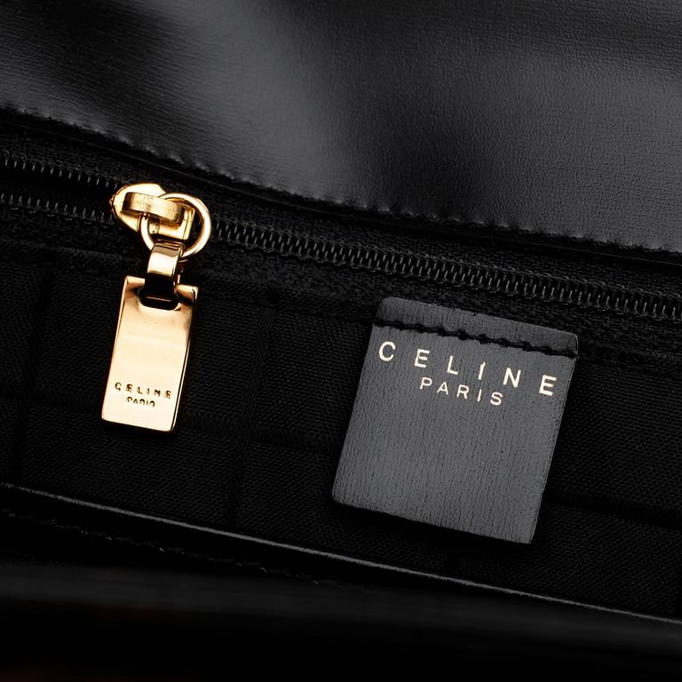 CÉLINE, a black leather top handle purse.