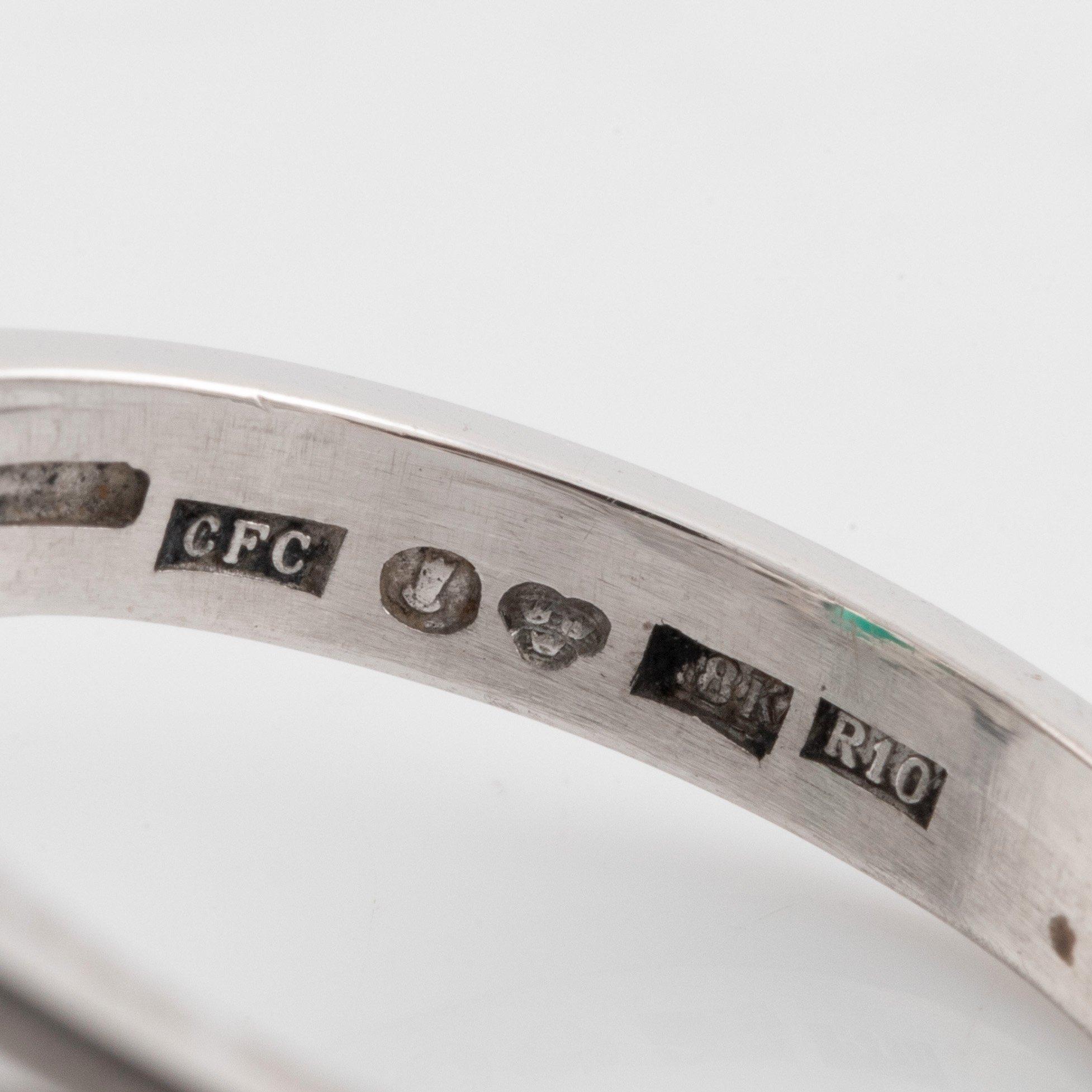 Ring med smaragd och runda briljantslipade diamanter.