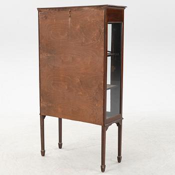 A mahogany vitrine cabinet from around the year.