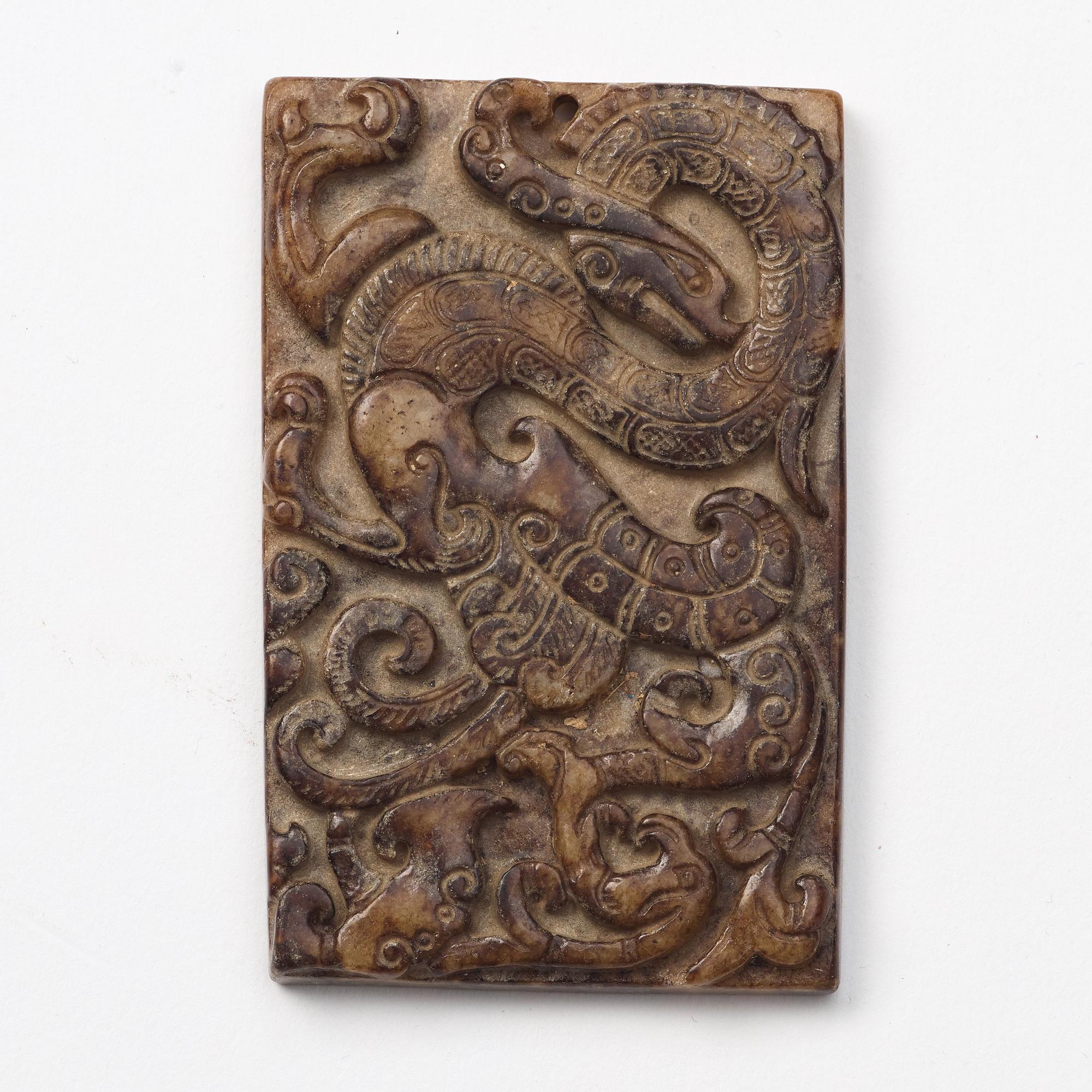 A group of three archaistic Chinese stone bi discs and two pendants.