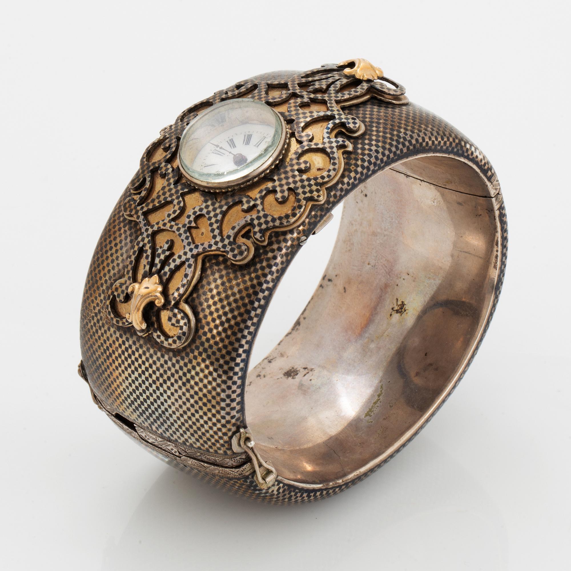 Silver bangle with watch.