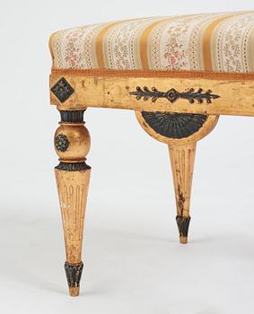 A Late gustavian armchair and stool in the manner of C G Gjörwll (1766-1837).