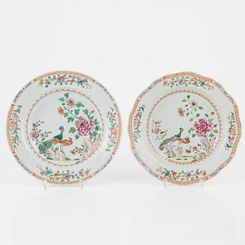 A set of three famille rose 'double peacock' dinner plates and an odd serving dish, Qing dynasty, Qianlong (1736-95).