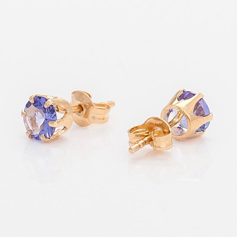 A pair of 14K gold earrings with tanzanites.