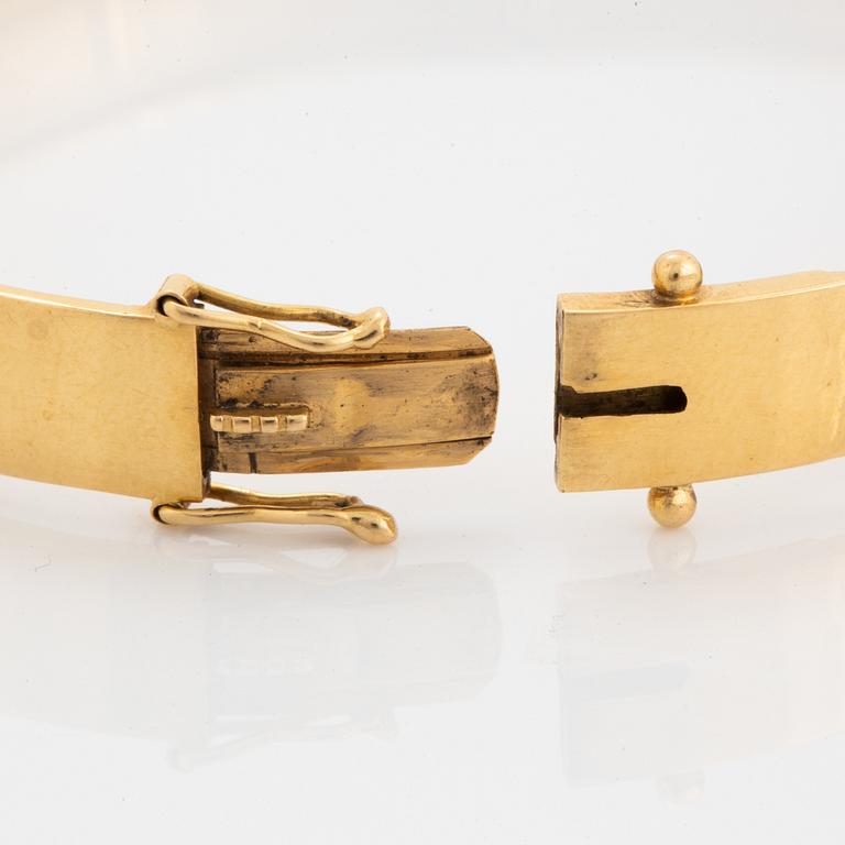 18K gold bangle and white synthetic stones.