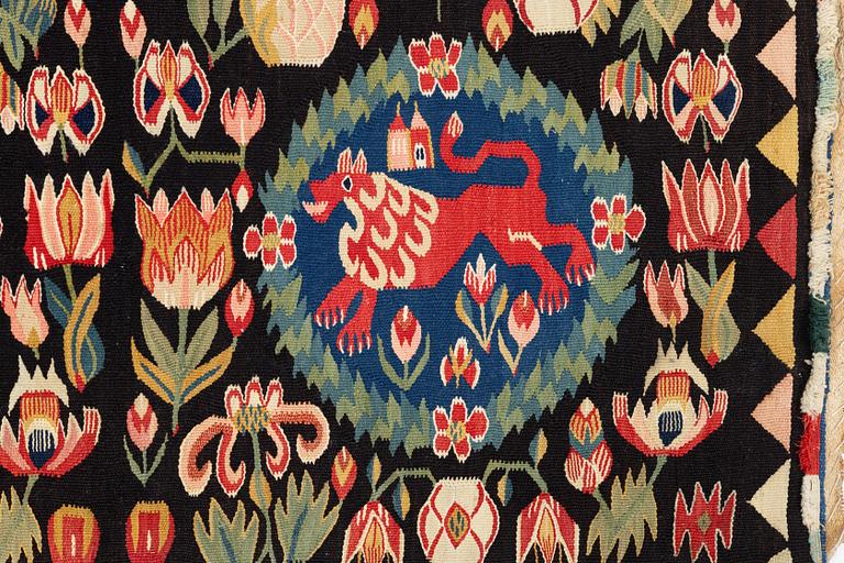 A cushion, 'Red Lion' (Rött Lejon), tapestry weave, c. 104 x 47 cm, Southwestern Scania, first part of the 19th century.