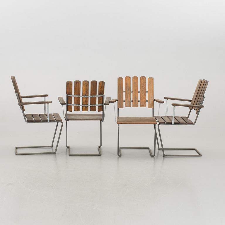 A GARDEN TABLE AND FOUR ARMCHAIRS FORM GRYTHYTTAN.