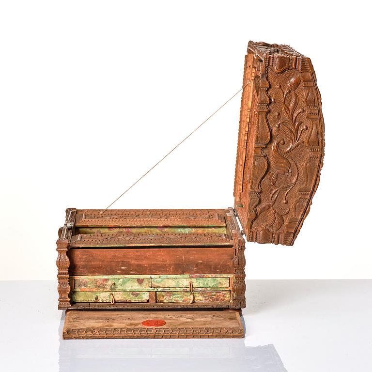 A baroque wedding casket, carved wood, dated 1725.