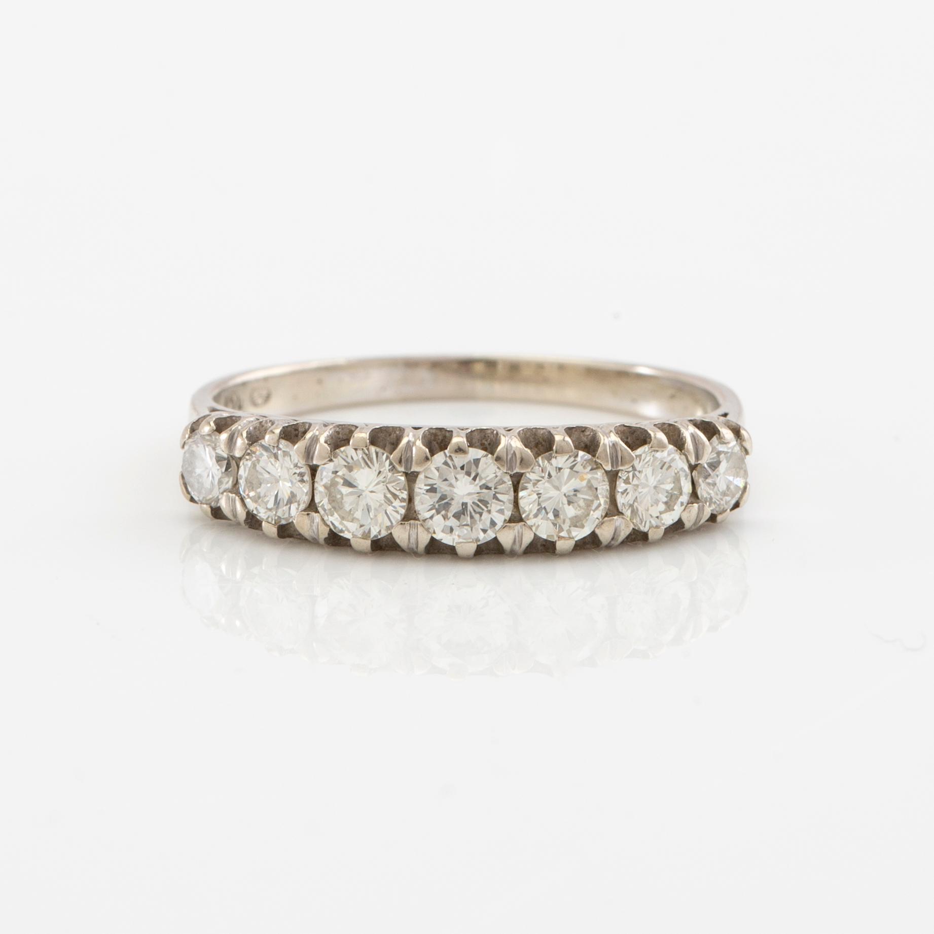 Half-eternity ring in 18K white gold set with round brilliant-cut diamonds, approximately 0.93 ct in total.
