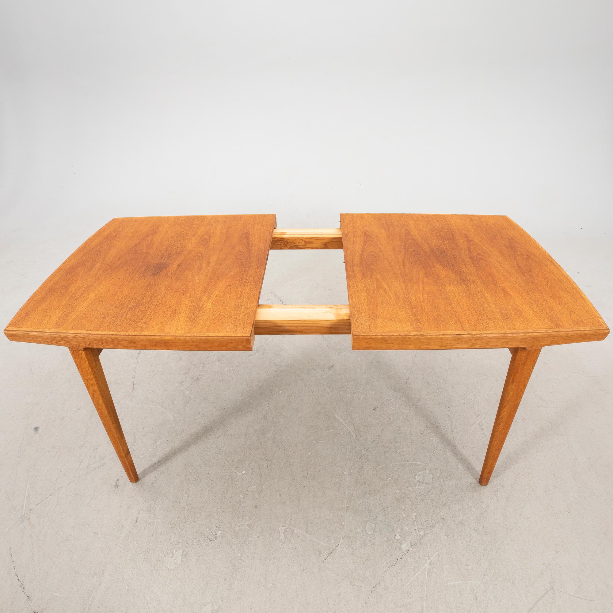 A 1950s teak dining table.