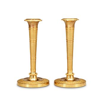 526. A pair of French Empire early 19th Century candlesticks.