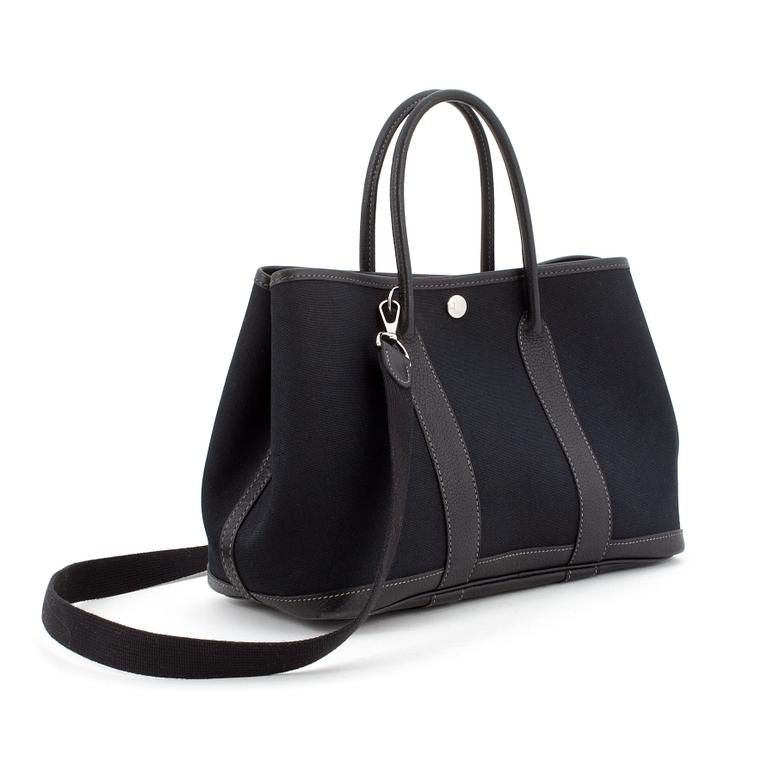 HERMÈS, a black canvas and leather bag, "Garden Party".