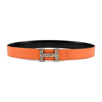 HERMÈS, a reversible belt, togo orange and black leather with silver colored H belt buckle.