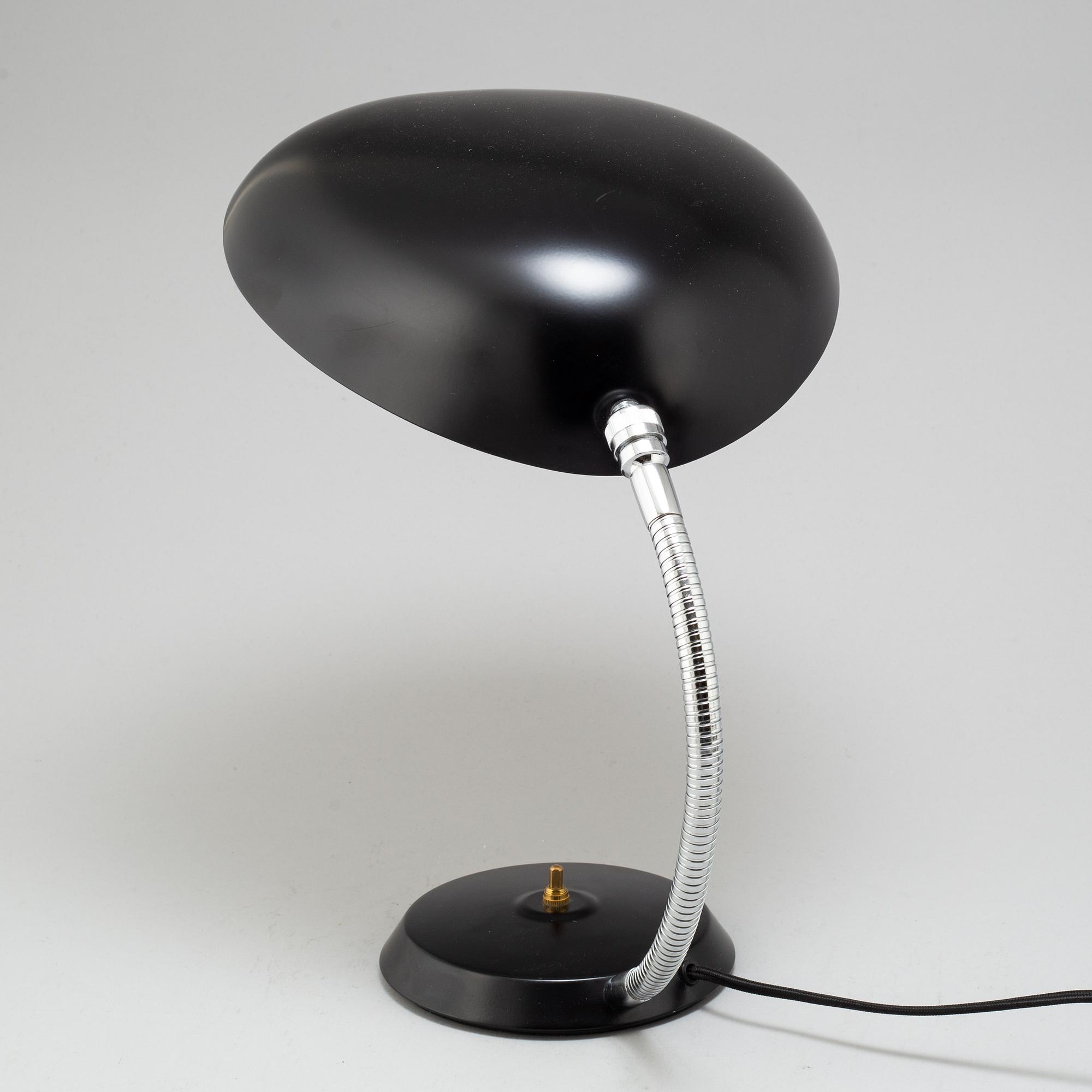 A 'Cobra' table lamp by Greta Magnusson Grossman, Gubi.