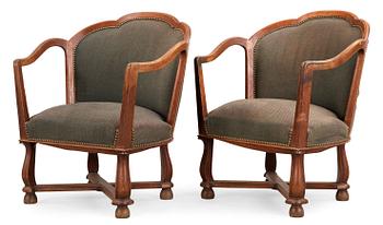 A pair of Ragnar Östman oak easy chairs, Sweden 1920's.