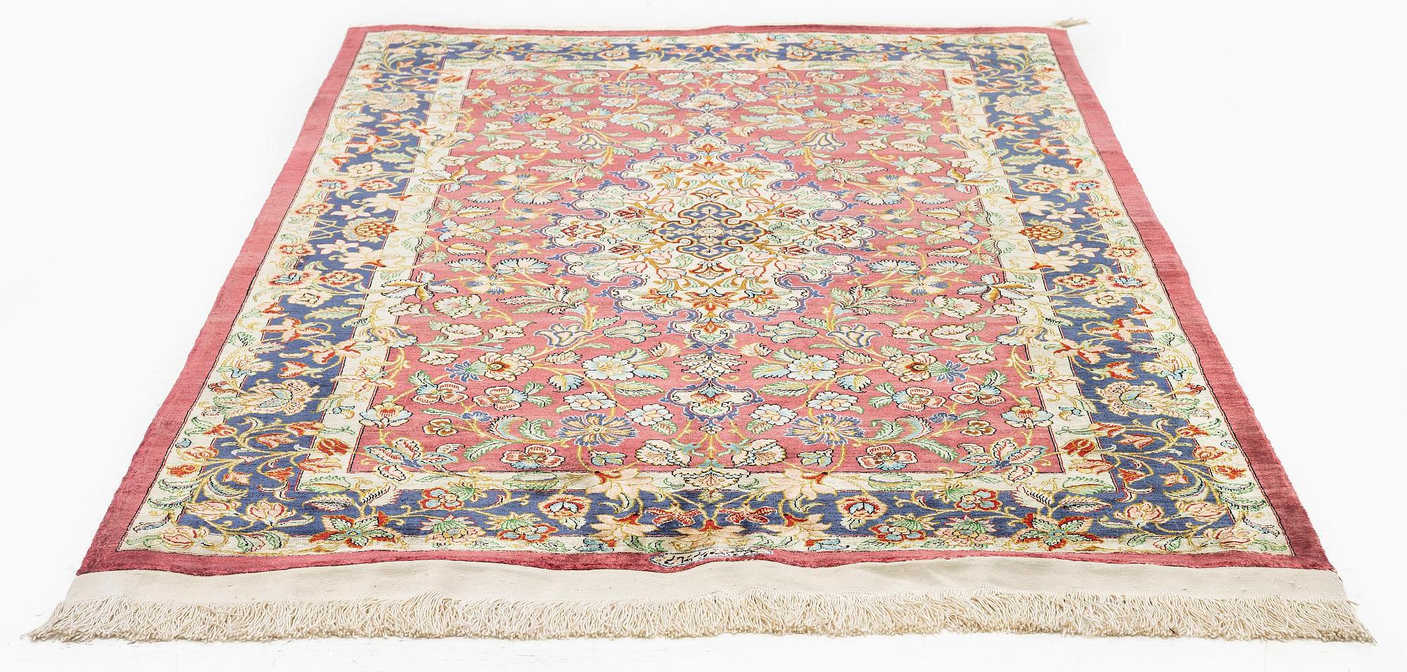 A silk Qum rug, Central Iran, signed, c. 170 x 101 cm.
