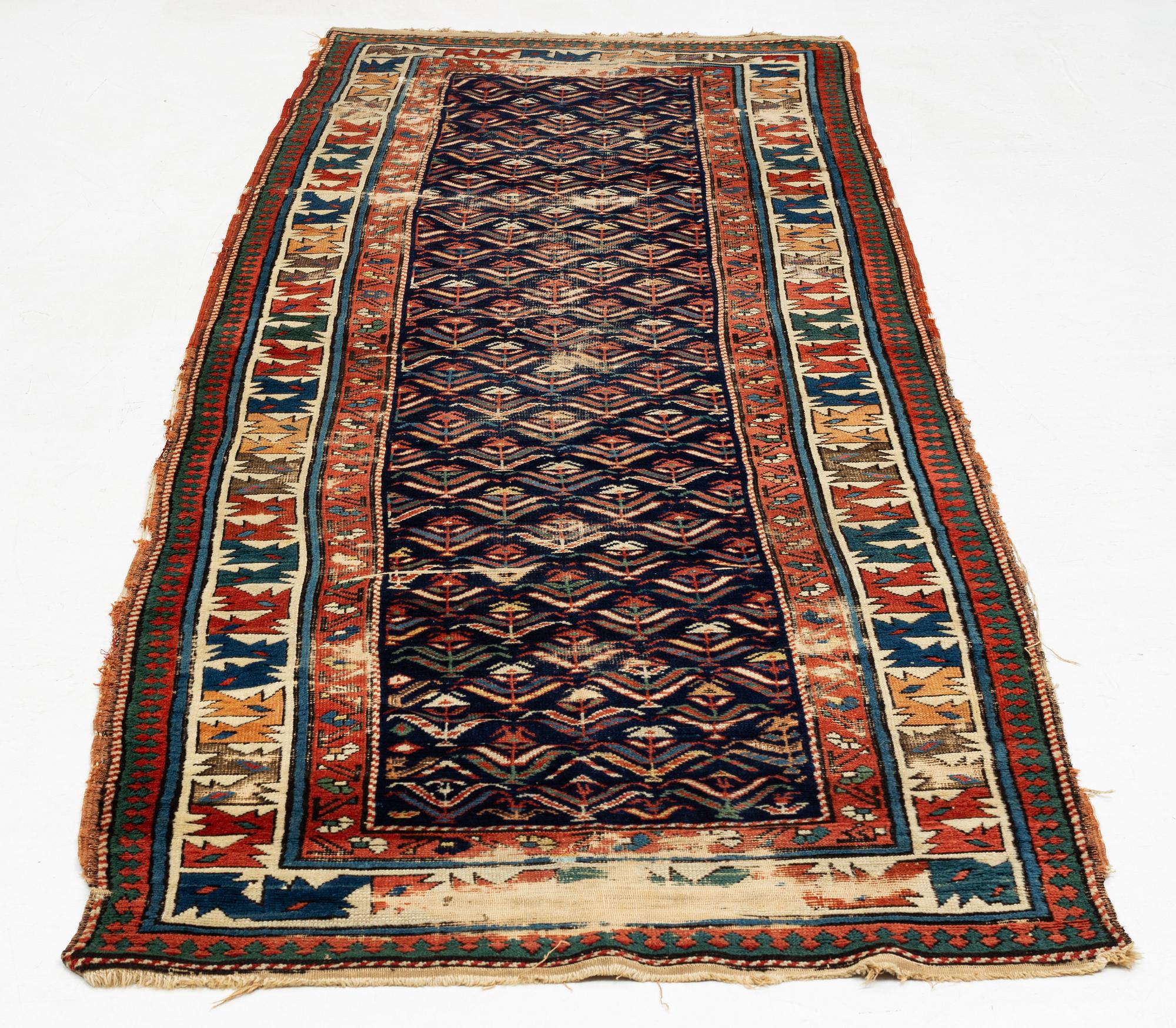 A antique Kazak gallery carpet, ca 310 x 105 cm.