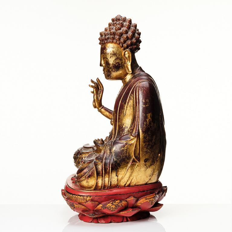 A large gilt and lacquered figure of a seated buddha, Qing dynasty, 19th Century.