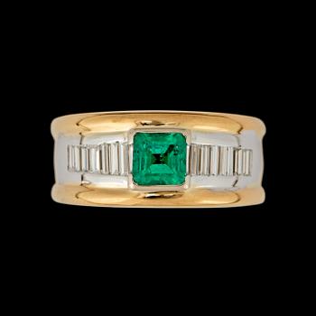 104. A step cut emerald, circa 0.80 ct and baguette cut diamond, circa 0.80 ct, ring.