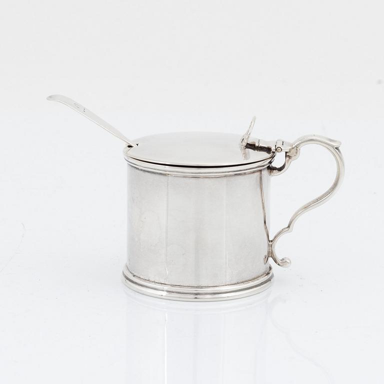 An English silver mustard pot and spoon, unidentified makers mark, London 1881 and the spoon 1874.