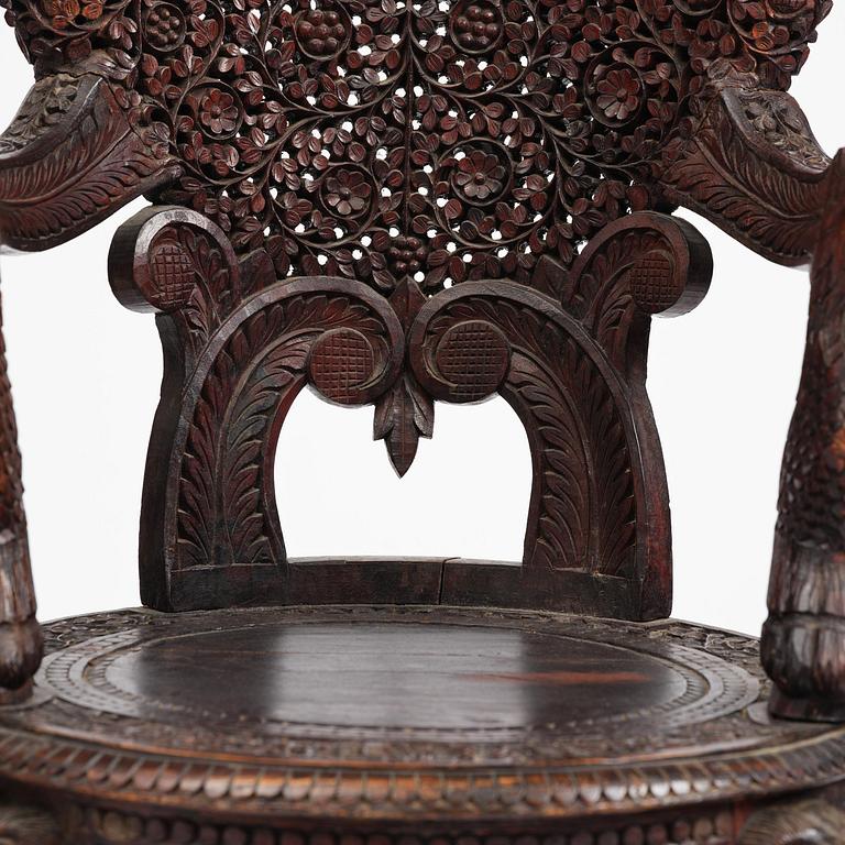 A pair of carved 'blackwood' armchairs, Bombay presidency, British Raj, circa 1880.